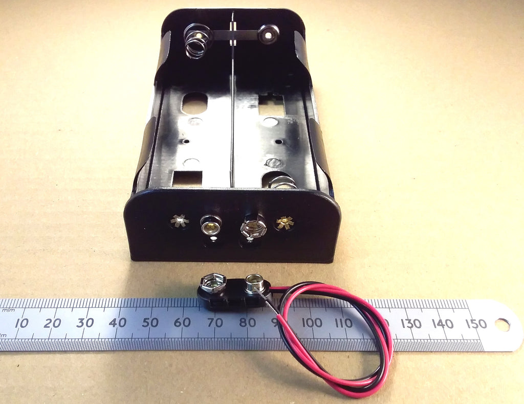 HJW Electronics listing for A black 4 D cell battery holder with metal contacts and attached red and black wires, shown on a beige background with a metal ruler for scale.